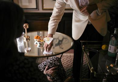 An image of a man in a suit and tie, Martini Masterclass. The Egerton House Hotel