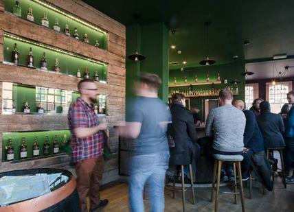 An image of a group of people at a bar, Grain & Glass. Grain & Glass