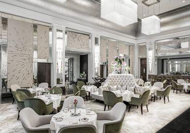 An image of a restaurant setting with tables and chairs, The Langham, Palm Court. The Langham, Palm Court