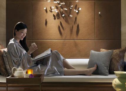 An image of a woman reading a book, Tea and Therapy. The Spa at Mandarin Oriental