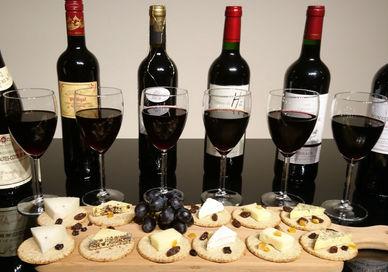 An image of wine and cheese on a table, Luxury Red Wine Tasting. Wine Cottage
